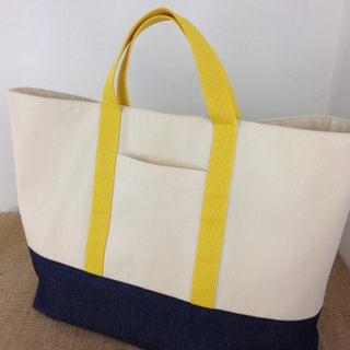Arden Shopper Bag in navy and cream with contrasting yellow fabric, showing front pocket detail.