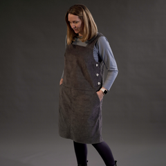 Female wearing Perdita Pinafore Dress sewing pattern in grey chunky needlecord
