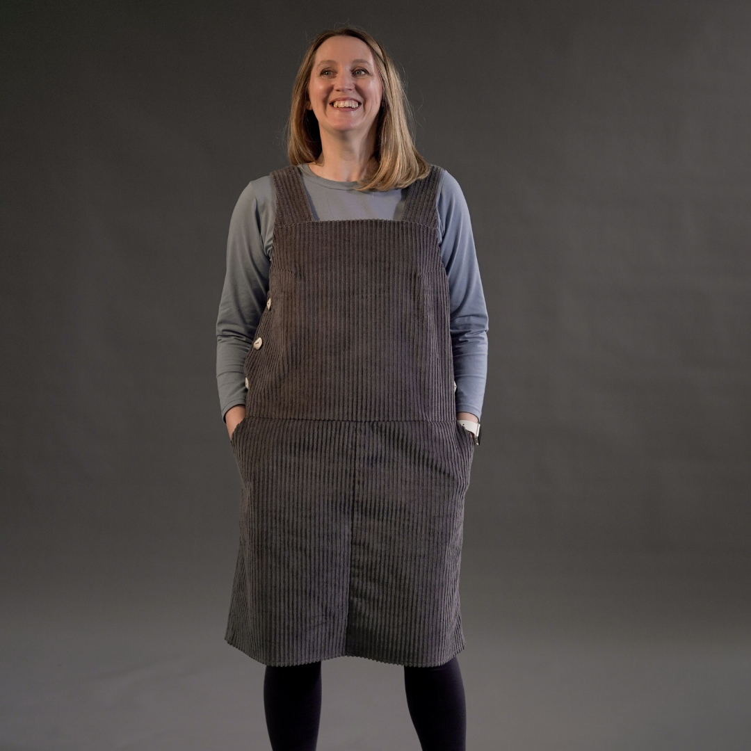 Female with hands in pockets wearing Perdita Pinafore Dress Sewing Pattern with Snug T-Shirt Sewing Pattern 