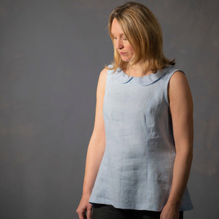 Female wearing the Iris top sleeveless sewing pattern in blue