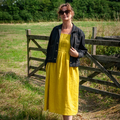Lady Wearing The Gertrude Jacket Sewing Pattern In Indigo Stretch Denim Fabric Over The Lavinia Dress In Laundered Linen Chartreuse