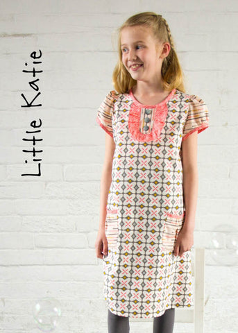 Girl Wearing The Little Katie Dress Sewing Pattern in a graphic print fabric