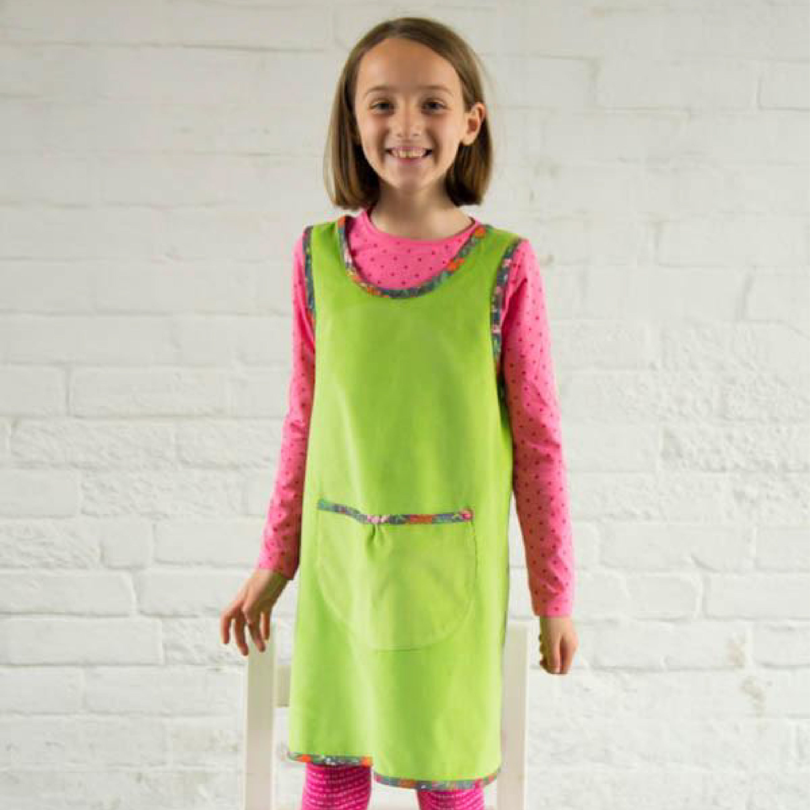 Girl wearing Little Bea and Leggings Sewing Pattern In a bright green fabric